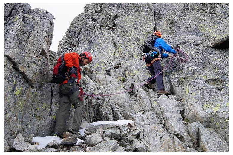 alpinists in progression roped off together to protect the fall of the student